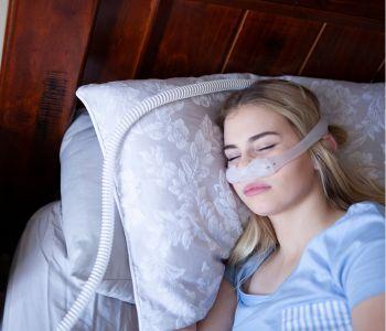 Woman Sleeping Comfortably at Home with CPAP Machine