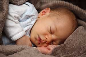 Baby Demonstrating Sleeping on Side to Prevent Snoring